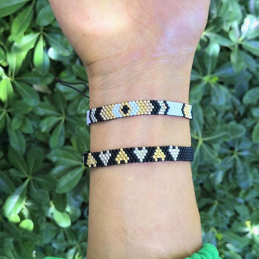 A model wearing the Chaquira Bracelet Set - Black & Brown - from Love Is Project